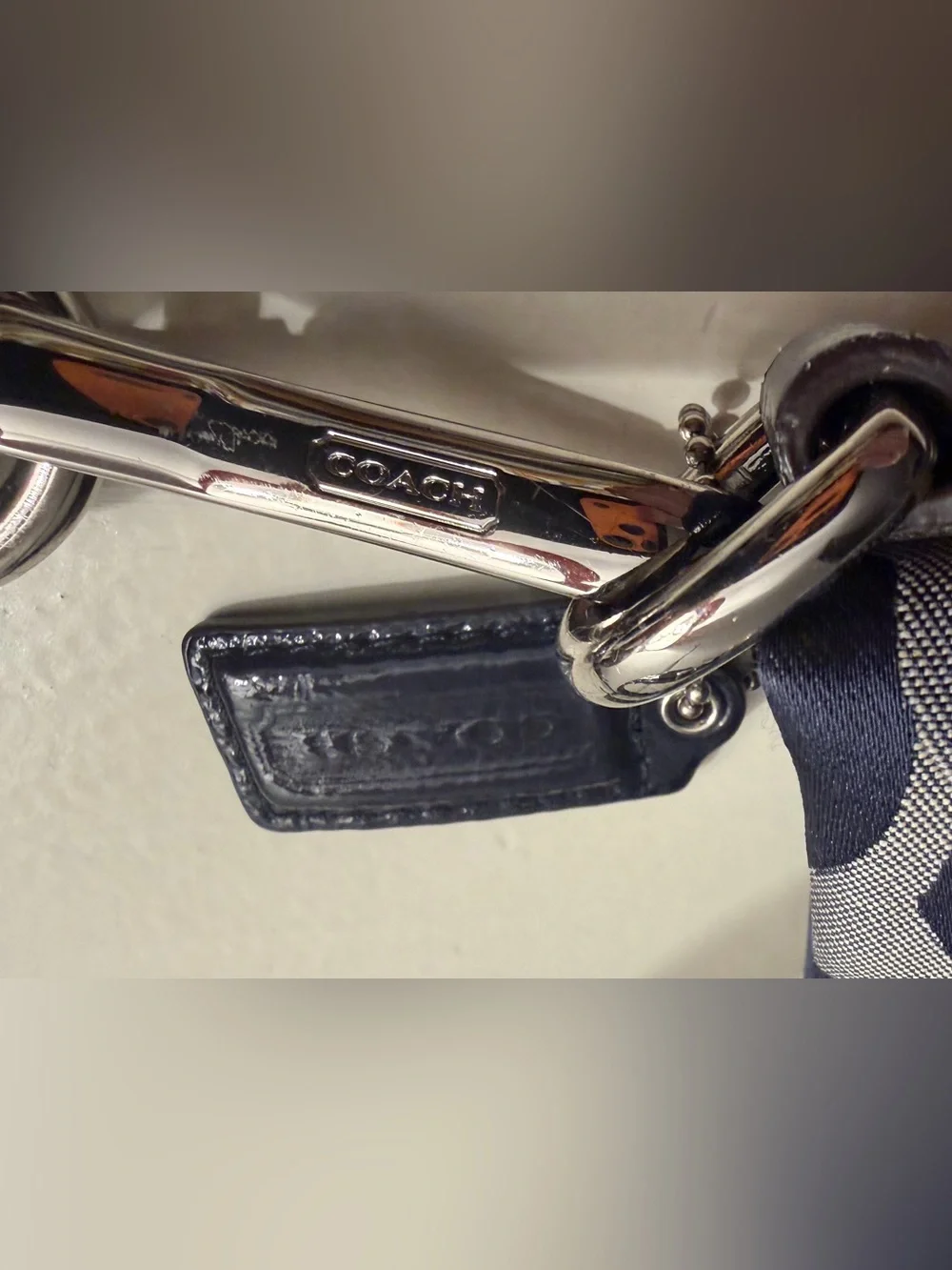 Coach navy , gray & metallic silver signature jacquard with navy leather trim.